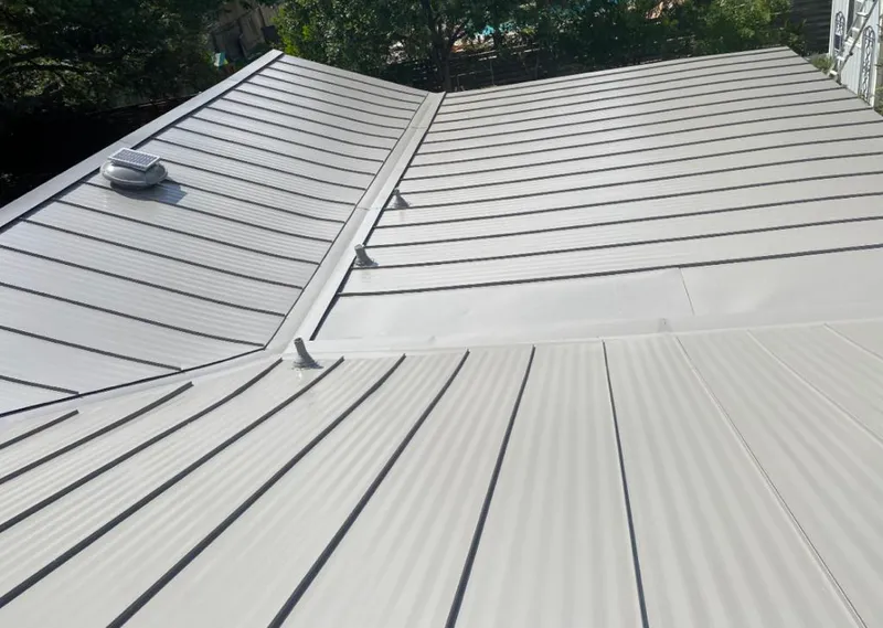 Solar attic fan installed on a metal roof for Roof Ventilation in Hialeah