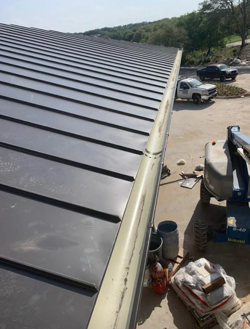 Standing seam panel and gutter detail on a metal roofing jobsite in Hialeah